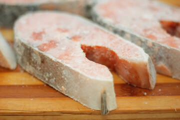 Frozen salmon raw red fish steak on the table