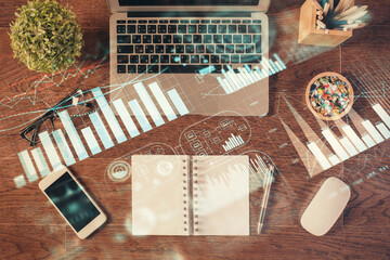 Stock market graph and top view computer on the table background. Multi exposure. Concept of financial education.