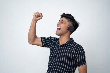 handsome man in half shirt is winning hand in the air on white background. happy concept.