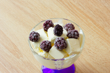 ice cream in a vase and berries on top