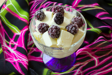 ice cream in a vase and berries on top