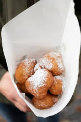 Fried beignets in a typically cornet paper, carnival food in low lands.