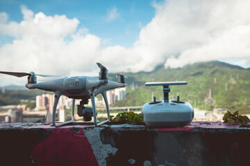 White drone with remote controller outdoors