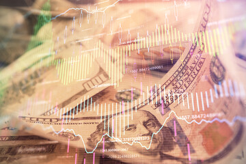 Double exposure of forex graph drawing over us dollars bill background. Concept of financial...