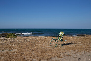 Deck chair on beach in a sunny summer day in Apulia, Italy