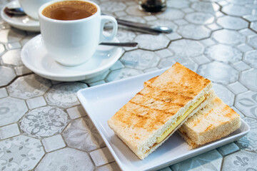 Breakfast toast set with coffee and toast bread with butter and kaya, a typical breakfast at cafe