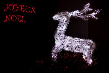 Rennes lumineux sur fond noir avec inscription joyeux Noël