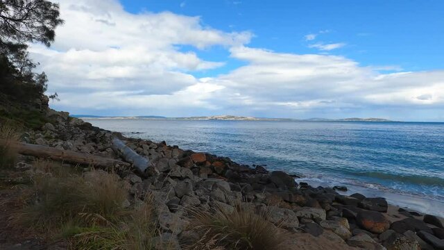 pristine wild landscape at Boronia Beach in Tasmania, Australia with lush vegetation and rocks on the shore