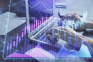 Double exposure of woman hands typing on computer and forex chart hologram drawing. Stock market invest concept.