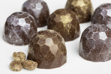 chocolate truffles with golden and silver shimmer and golden coffee beans