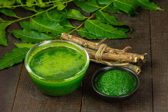 Neem leaf used as ayurvedic medicine with neem stick on wooden background.