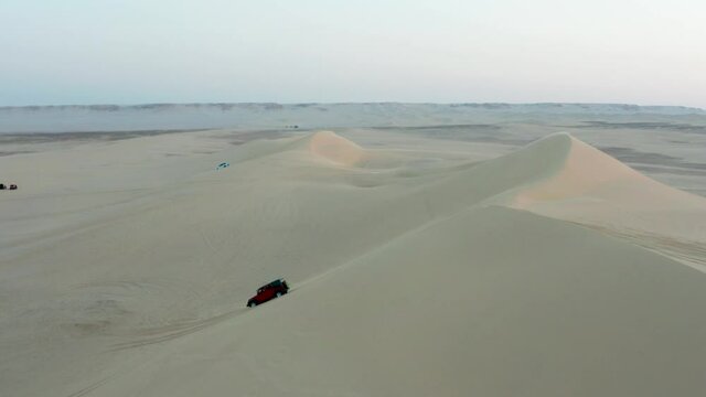 Desert Safari off road SUV bashing through the arabian sand dunes, the vehicle rides on desert sand-dune.