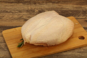 Raw whole chicken breast with skin
