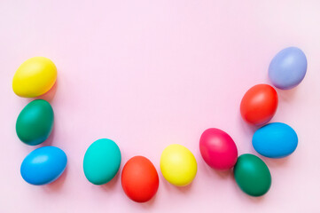 colorful easter eggs on pink background with copy space. Easter background