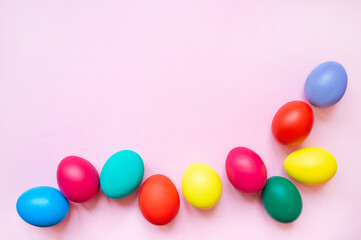 colorful easter eggs on pink background with copy space. Easter background