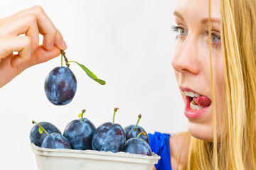 Girl holds plum fruits