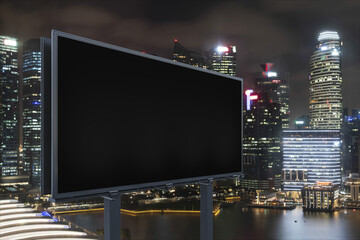 Blank black road billboard with Singapore cityscape background at night time. Street advertising poster, mock up, 3D rendering. Side view. The concept of marketing communication to sell idea.