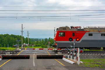 TRANS-Siberian railway, electric freight locomotive at the crossing © oroch2