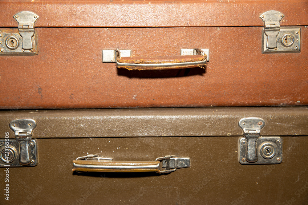 Poster stack of old retro suitcases close up