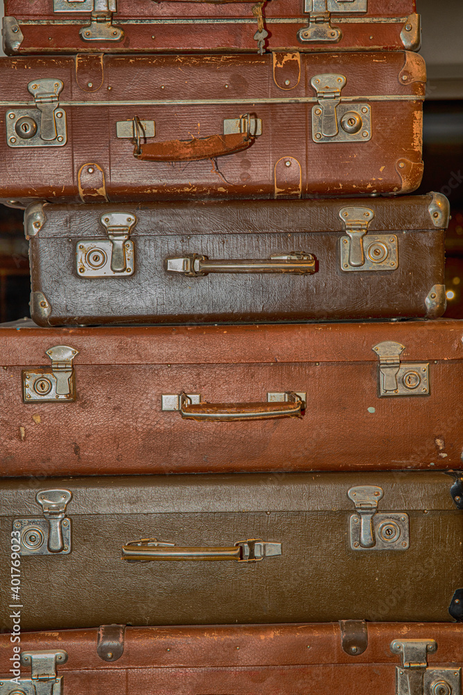 Poster stack of old retro suitcases close up