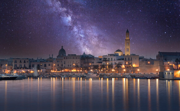 Cityscape of Bari at sunset with Basilica of San Nicola and Romanesque Cathedral. Bari, Puglia, Italy. seafront city view from marina at night. Apulia region