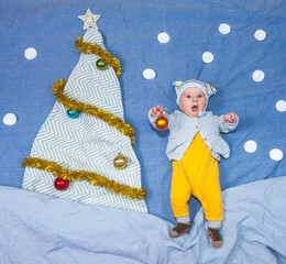 Baby decorates christmas tree. Happy New Year!