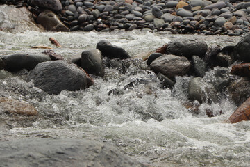 Heddon river flowing through the valley and over rocky ground