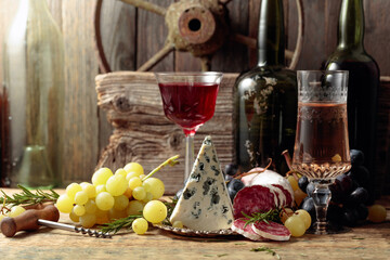 Rustic still life with wine and snacks.