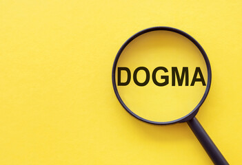 The word DOGMA is written on a magnifying glass on a yellow background.