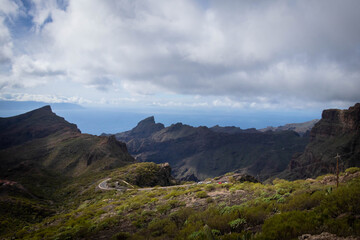 
mountain views with asphalt road and buildings in the green mountains of tenerife