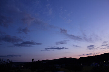 evening vanilla sky background with dark mountain silhouette