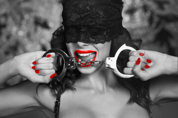 Sexy woman bite handcuffs in lace blindfold, black and white selective coloring with red, bdsm - obrazy, fototapety, plakaty