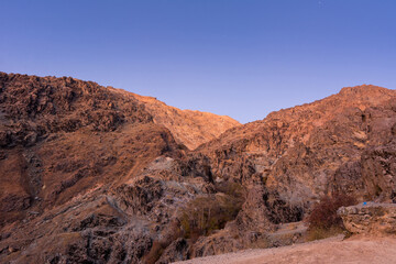 Barren mountain in Darband valley in dawn against purple sky in the Tochal mountain. A popular recreational region for Tehran's residents