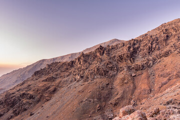 Barren mountain in Darband valley in dawn against purple sky in the Tochal mountain. A popular recreational region for Tehran's residents