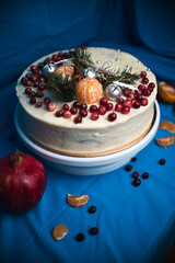 Festive cake decorated for Christmas and New Year on a blue background