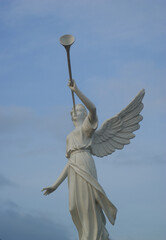 an angel statue with holding trumpet in Cathedral of Dili Timor Leste