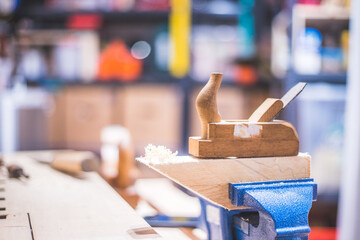 Home handyman using a plane for smoothing down a piece of timber
