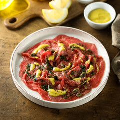 Homemade beef carpaccio with mustard sauce