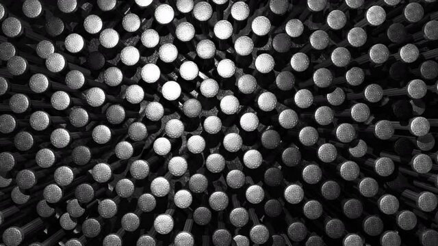 Steel metallic black chrome and silver nail heads background. Industry technology and structure concept. Abstract backdrop advertising banner. Top view. 4K footage video motion graphic. Seamless loop