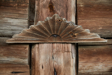 Traditional Russian wood carving, vintage wooden amulet on the wall of a log house in the village