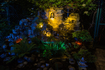 creative fountain with lighting in a garden