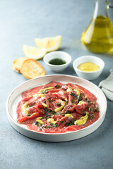 Homemade beef carpaccio with mustard sauce