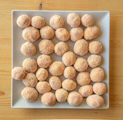 Meatballs coated in breadcrumbs on a square plate