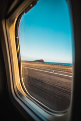 Clouds and sky as seen through window of in airplane