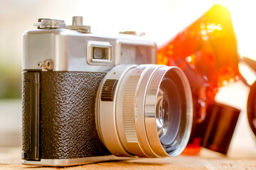 Retro film photo camera. Old vintage camera portrait on wooden background