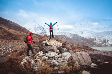 Naklejka premium Two women hikers hiking in winter mountains