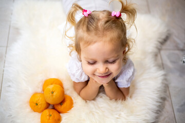 Happy child and lover of tangerines. Smells like a holiday.