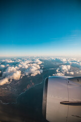 Fototapeta na wymiar Clouds and sky as seen through window of in airplane