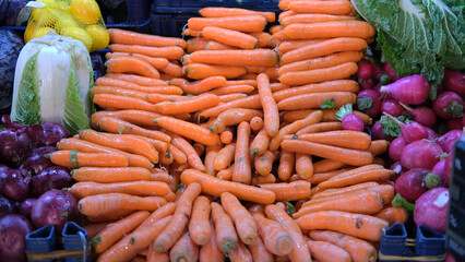 carrot and vegetable stalls in the market for vegans