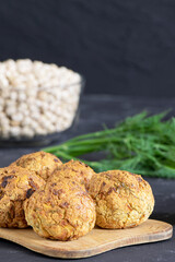 Fresh vegetarian food. Vegetarian baked falafel with parsley. Falafel balls. Chickpea and onion. Helthy food. Vertical orientation